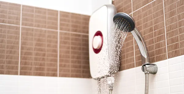 Tankless electric water heater supplying continuous hot water in a bathroom